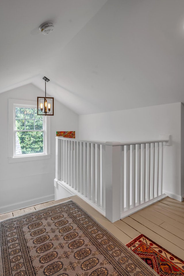 269 S Hanover Ave, Lexington, KY 40502 - corridor with lofted ceiling, an upstairs landing, a chandelier, and wood finished floors
