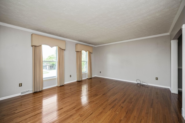 unfurnished room featuring wood finished floors, a textured ceiling, baseboards, and ornamental molding