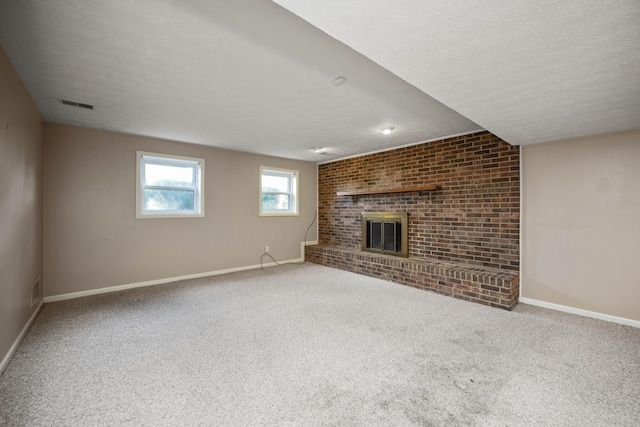 unfurnished living room featuring baseboards, carpet flooring, and a brick fireplace