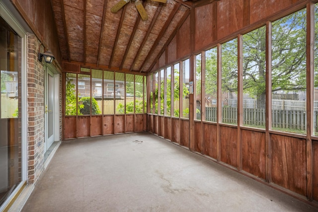 unfurnished sunroom with ceiling fan and lofted ceiling