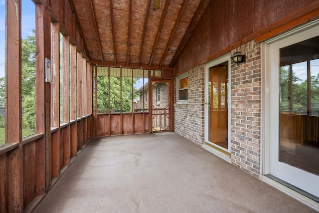 unfurnished sunroom with lofted ceiling