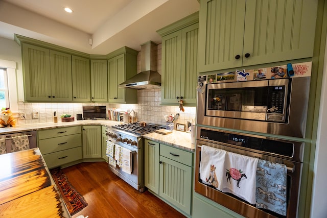 215 Bradley Ln, Lexington, KY 40511 - kitchen featuring green cabinets, wall chimney exhaust hood, stainless steel appliances, tasteful backsplash, and recessed lighting