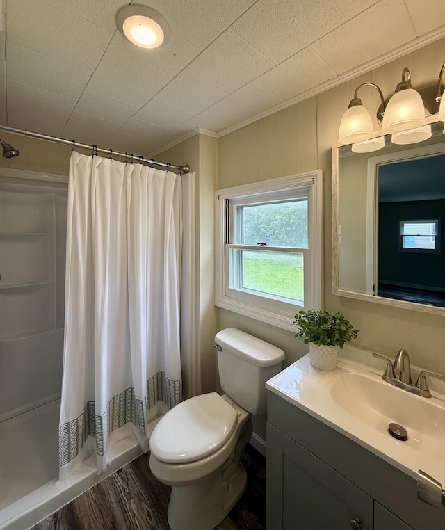 605 Prospect St, Berea, KY 40403 - bathroom featuring vanity, toilet, wood finished floors, a shower stall, and ornamental molding