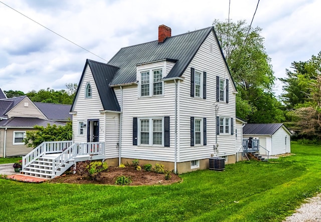 605 Prospect St, Berea, KY 40403 - view of front facade with a chimney, metal roof, a front lawn, central AC, and an outdoor structure