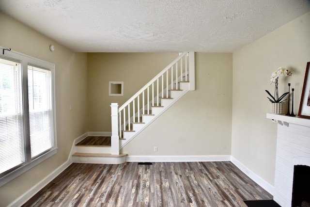 605 Prospect St, Berea, KY 40403 - stairway with a textured ceiling, wood finished floors, baseboards, and a brick fireplace