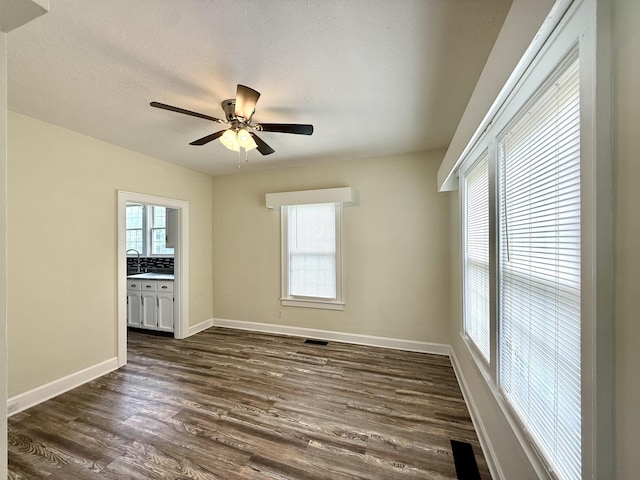 605 Prospect St, Berea, KY 40403 - unfurnished room with ceiling fan, plenty of natural light, dark wood finished floors, a sink, and a textured ceiling