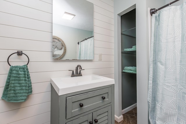 387 W Ila Ave, Danville, KY 40422 - bathroom featuring wood walls, vanity, and a shower with shower curtain