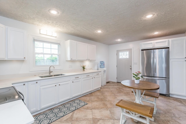 387 W Ila Ave, Danville, KY 40422 - kitchen with freestanding refrigerator, a sink, a textured ceiling, white cabinets, and light countertops