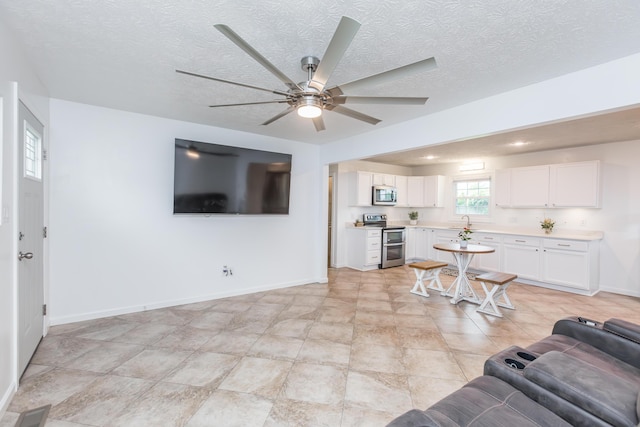 387 W Ila Ave, Danville, KY 40422 - living area with a ceiling fan, baseboards, and a textured ceiling