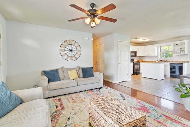 35 Prewitt Place Dr, Somerset, KY 42503 - living area with ceiling fan, light wood finished floors, and baseboards