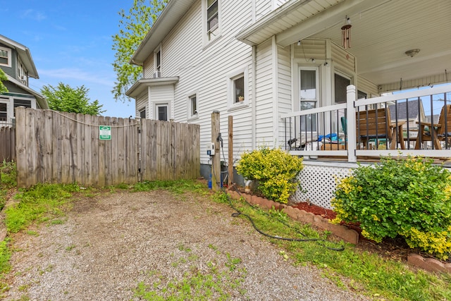 view of side of property featuring fence
