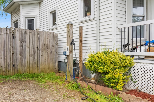 view of side of home featuring fence