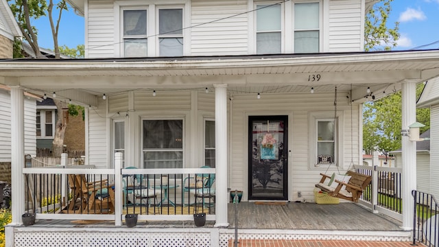 entrance to property featuring a porch