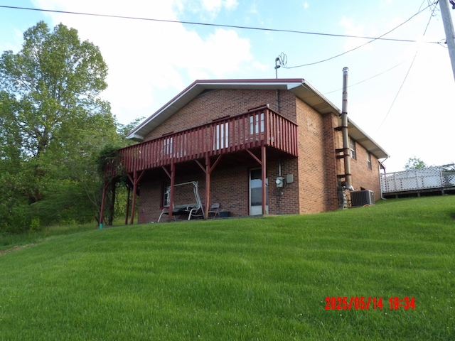 157 Deskins Ln, Frenchburg, KY 40322 - back of house featuring brick siding, a lawn, cooling unit, and a deck