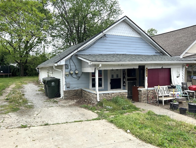 430 Morgan Ave, Lexington, KY 40505 - bungalow with a porch, roof with shingles, a trampoline, and stone siding