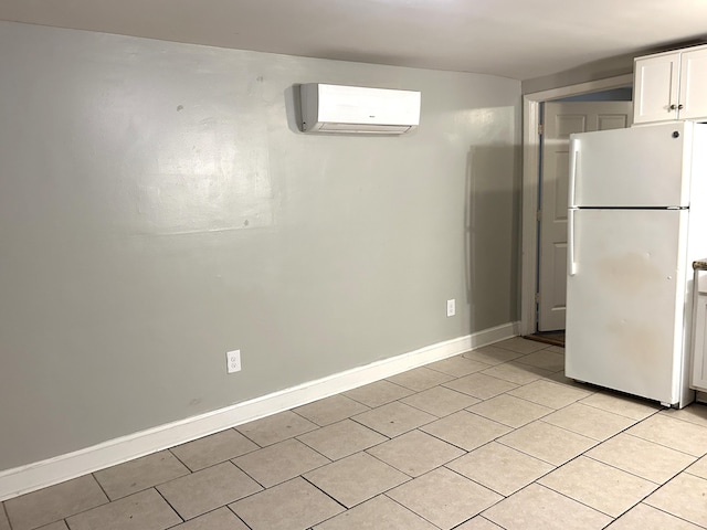 430 Morgan Ave, Lexington, KY 40505 - below grade area featuring freestanding refrigerator, a wall mounted AC, light tile patterned flooring, and baseboards