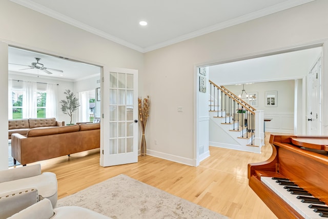 9118 Harrodsburg Rd, Wilmore, KY 40390 - living room with light wood finished floors, a chandelier, ornamental molding, stairway, and recessed lighting