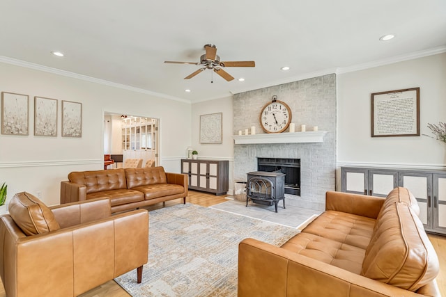 9118 Harrodsburg Rd, Wilmore, KY 40390 - living area featuring a ceiling fan, ornamental molding, recessed lighting, light wood-style flooring, and a wood stove