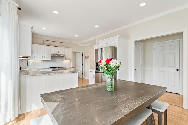 9118 Harrodsburg Rd, Wilmore, KY 40390 - kitchen featuring stainless steel fridge with ice dispenser, a sink, under cabinet range hood, a peninsula, and white cabinets