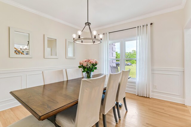 9118 Harrodsburg Rd, Wilmore, KY 40390 - dining room with a chandelier, ornamental molding, a decorative wall, light wood-style flooring, and a wainscoted wall