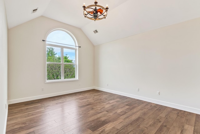 9118 Harrodsburg Rd, Wilmore, KY 40390 - empty room featuring a chandelier, lofted ceiling, dark wood-style floors, and baseboards
