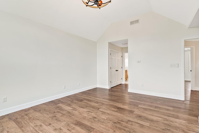 9118 Harrodsburg Rd, Wilmore, KY 40390 - unfurnished room with a chandelier, vaulted ceiling, wood finished floors, and baseboards