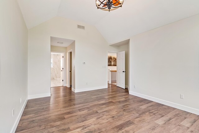 9118 Harrodsburg Rd, Wilmore, KY 40390 - unfurnished living room with lofted ceiling, wood finished floors, a chandelier, and baseboards