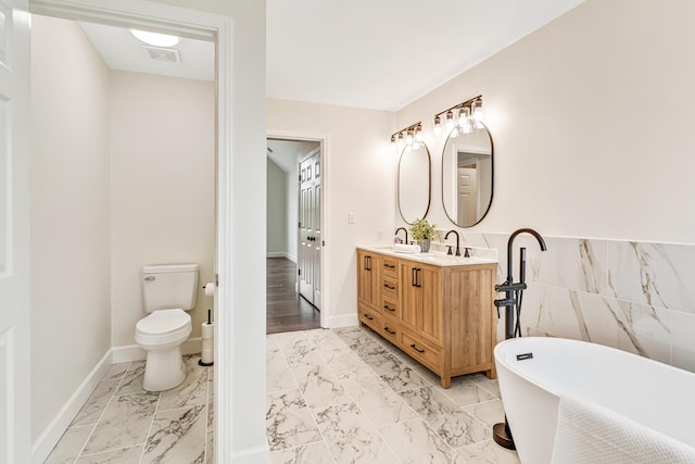 9118 Harrodsburg Rd, Wilmore, KY 40390 - full bath featuring toilet, marble finish floors, a freestanding tub, and double vanity