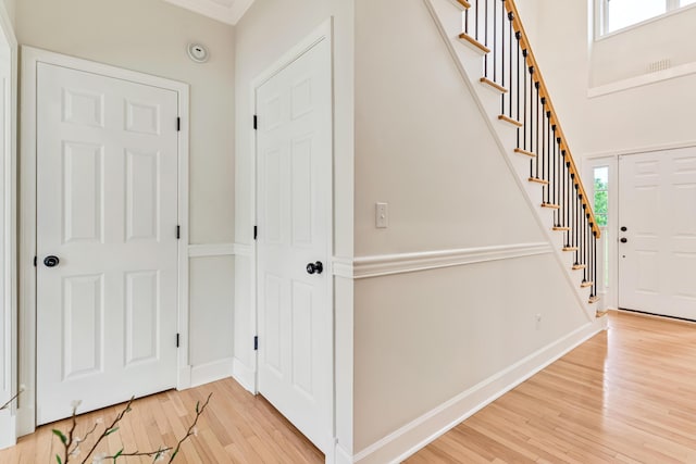 9118 Harrodsburg Rd, Wilmore, KY 40390 - entryway with light wood finished floors, baseboards, stairs, and ornamental molding