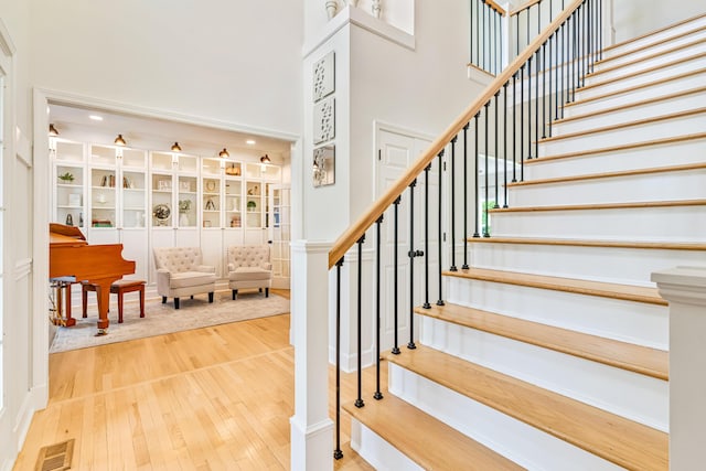 9118 Harrodsburg Rd, Wilmore, KY 40390 - staircase with a towering ceiling and hardwood / wood-style flooring