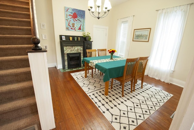 204 S Walnut St, Wilmore, KY 40390 - dining area with stairs, a chandelier, baseboards, and dark wood-type flooring