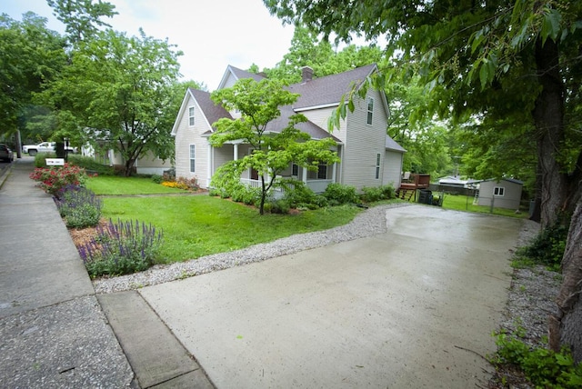 204 S Walnut St, Wilmore, KY 40390 - view of home's exterior featuring roof with shingles, a lawn, and a chimney