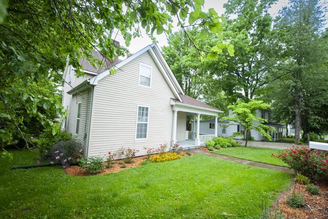 204 S Walnut St, Wilmore, KY 40390 - view of front of home featuring covered porch, a front lawn, a shingled roof, and a chimney