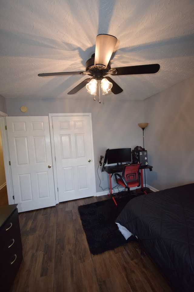 bedroom with dark wood-style flooring, baseboards, and ceiling fan