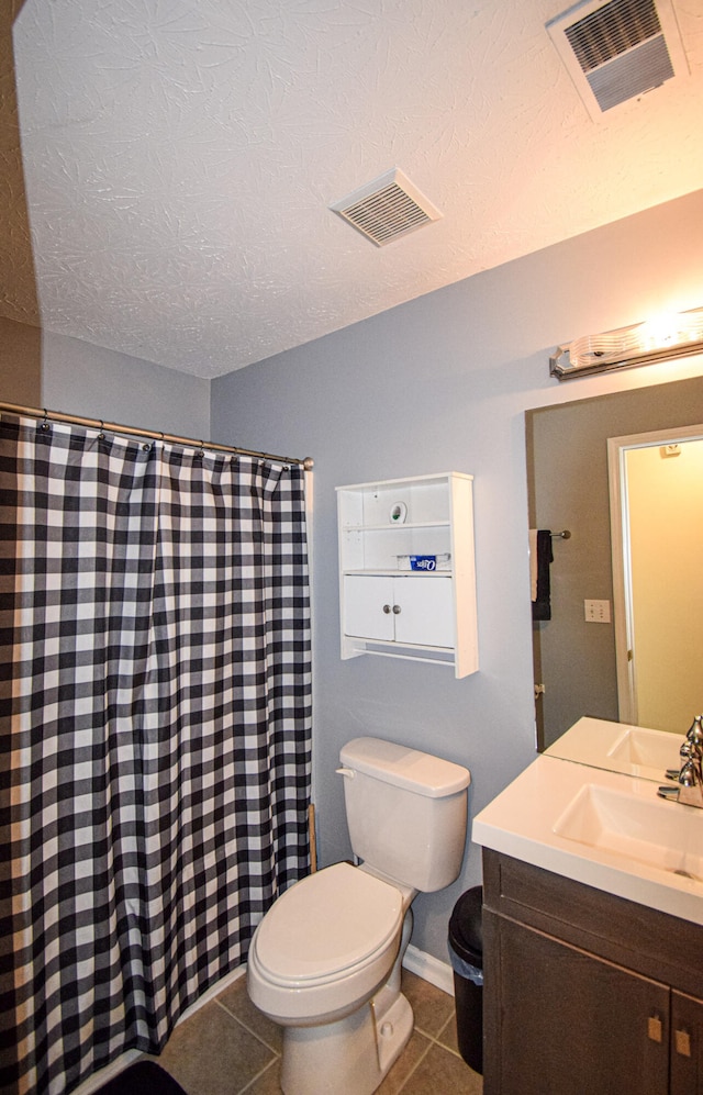 bathroom featuring tile patterned floors, toilet, vanity, a textured ceiling, and a shower with shower curtain