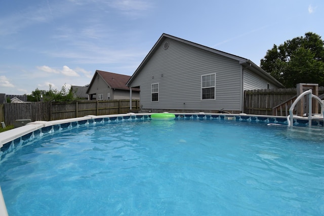 view of swimming pool with a fenced backyard