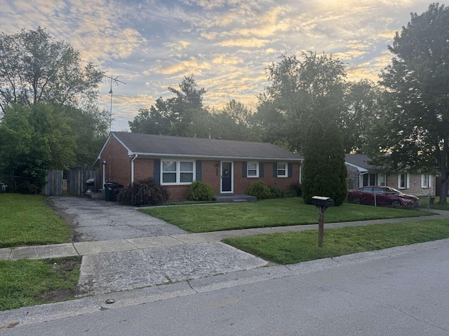 780 Nancy St, Versailles, KY 40383 - ranch-style home featuring brick siding, a yard, and driveway