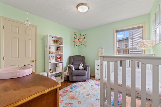829 Lauderdale Dr, Lexington, KY 40515 - bedroom featuring wood finished floors and a nursery area