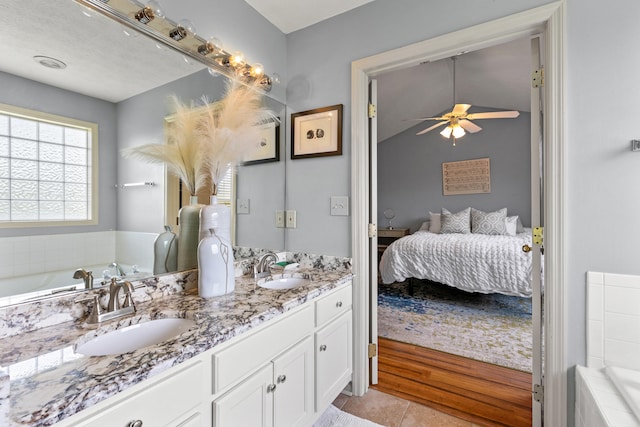 829 Lauderdale Dr, Lexington, KY 40515 - full bath featuring connected bathroom, double vanity, ceiling fan, a garden tub, and tile patterned flooring