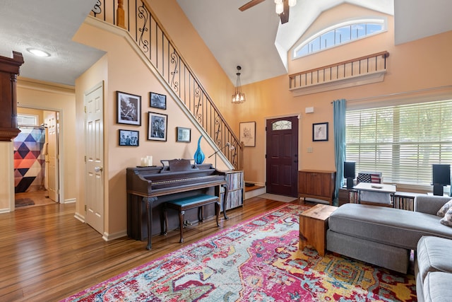 829 Lauderdale Dr, Lexington, KY 40515 - living area with wood finished floors, ceiling fan, stairs, and high vaulted ceiling