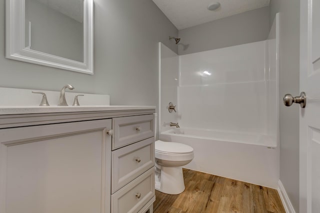 full bathroom with toilet, wood finished floors, shower / washtub combination, and vanity
