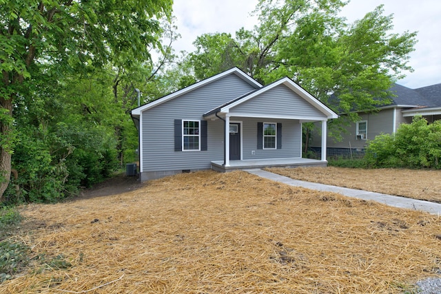 view of front of property with covered porch, crawl space, and central air condition unit