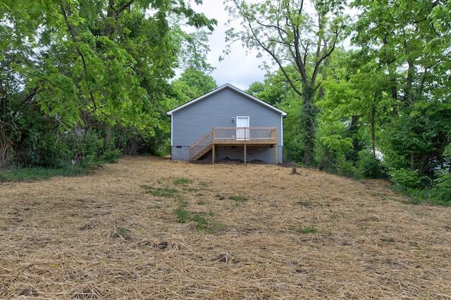 rear view of property with a wooden deck, crawl space, and stairway