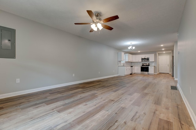 unfurnished living room featuring electric panel, a ceiling fan, baseboards, light wood-style floors, and recessed lighting