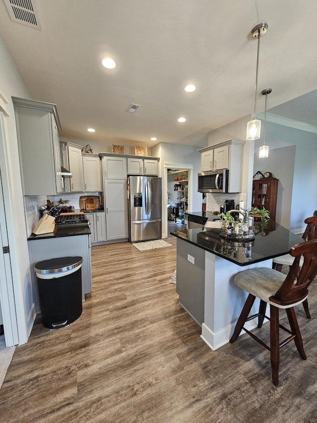 229 Old Station Rd, Frankfort, KY 40601 - kitchen with appliances with stainless steel finishes, dark countertops, tasteful backsplash, wood finished floors, and recessed lighting