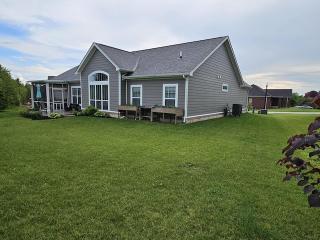 229 Old Station Rd, Frankfort, KY 40601 - back of property with roof with shingles, central AC unit, a yard, and a sunroom