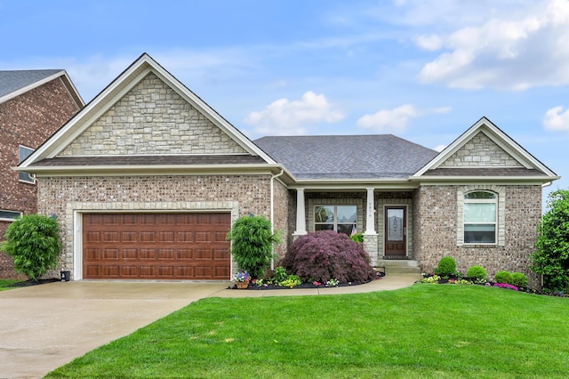 craftsman-style home with a front lawn, an attached garage, concrete driveway, a shingled roof, and brick siding