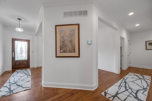 entrance foyer featuring hardwood / wood-style floors, baseboards, crown molding, and recessed lighting