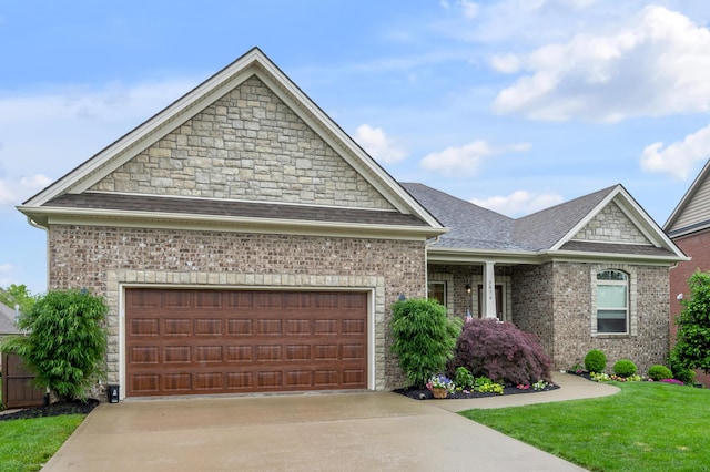craftsman-style home featuring driveway, a garage, a front lawn, roof with shingles, and brick siding