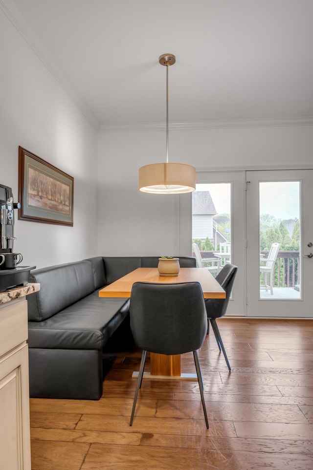 dining room with ornamental molding, light wood finished floors, and breakfast area
